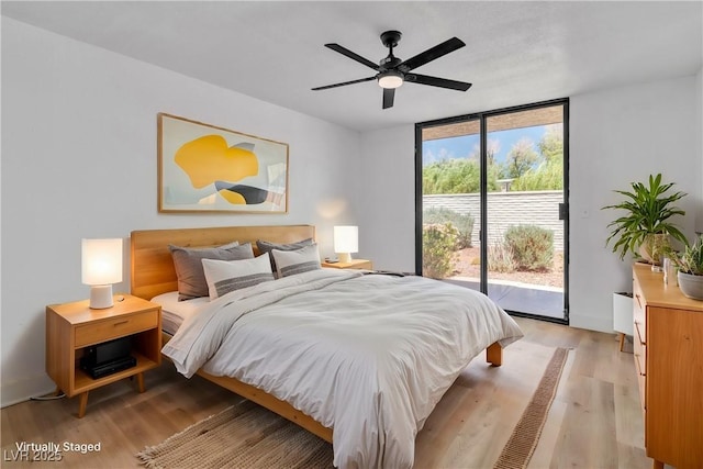 bedroom featuring access to outside, floor to ceiling windows, ceiling fan, and light hardwood / wood-style floors