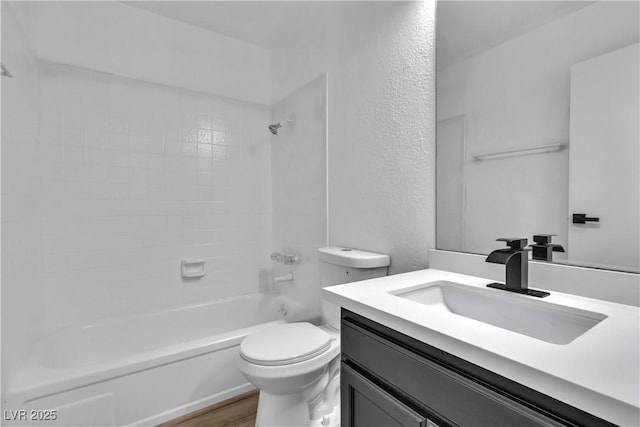 full bathroom with hardwood / wood-style flooring, vanity, toilet, and tiled shower / bath combo