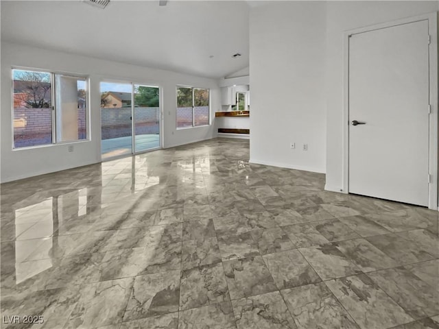 unfurnished living room featuring lofted ceiling