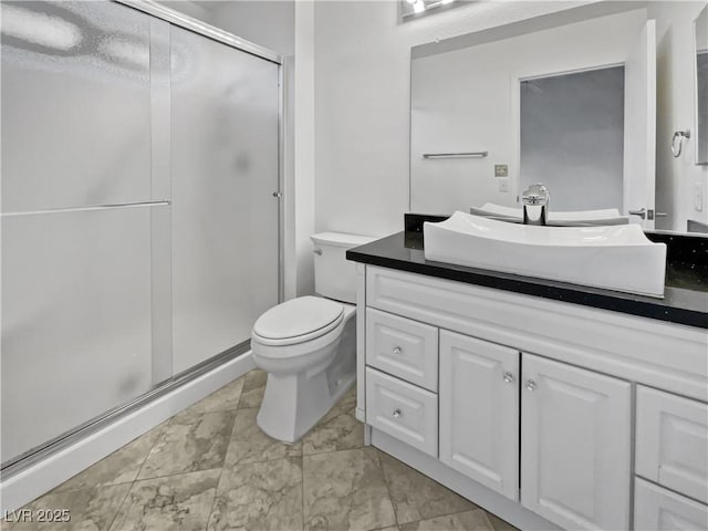 bathroom with a shower with door, vanity, and toilet