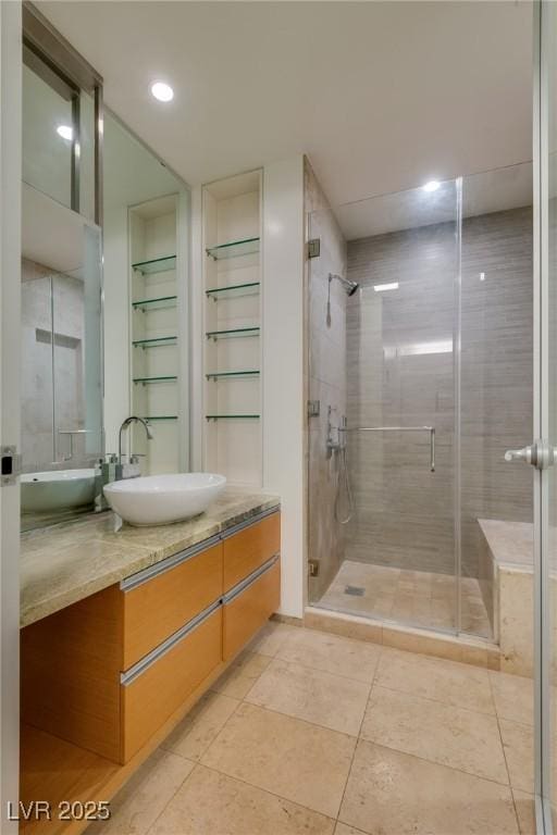 bathroom featuring vanity, tile patterned floors, and a shower with door