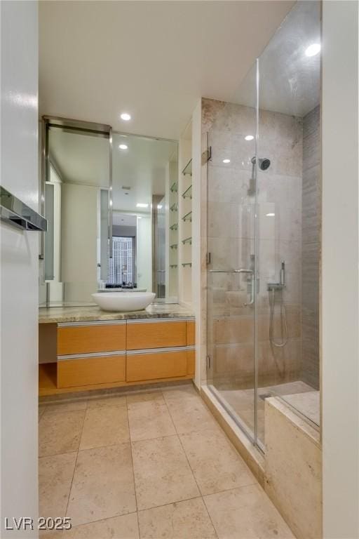 bathroom featuring vanity, an enclosed shower, and tile patterned floors