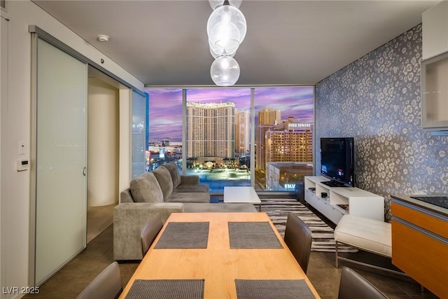 living room featuring tile patterned flooring and a wall of windows