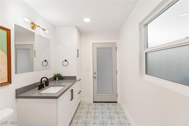 bathroom with tile patterned floors, vanity, and toilet