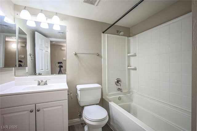 full bathroom featuring shower / bathing tub combination, vanity, a textured ceiling, and toilet