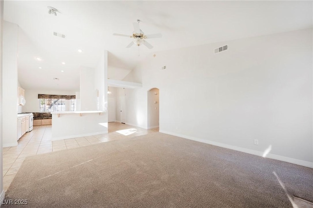 unfurnished living room featuring high vaulted ceiling, light tile patterned floors, and ceiling fan