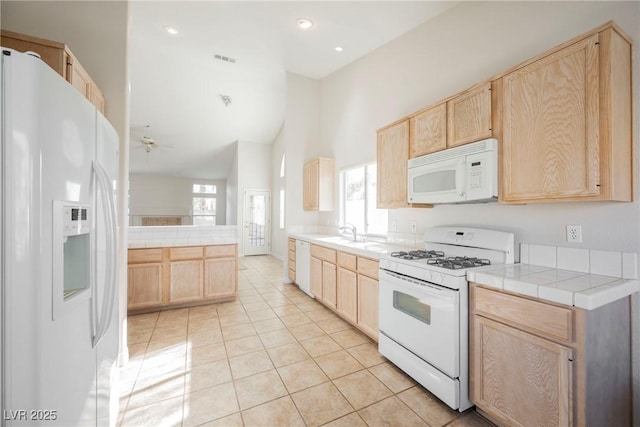 kitchen with ceiling fan, white appliances, high vaulted ceiling, and light brown cabinets