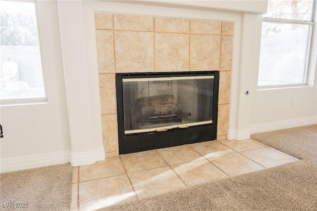 details featuring a tiled fireplace and carpet flooring