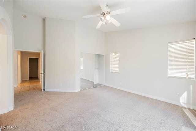 carpeted spare room with ceiling fan