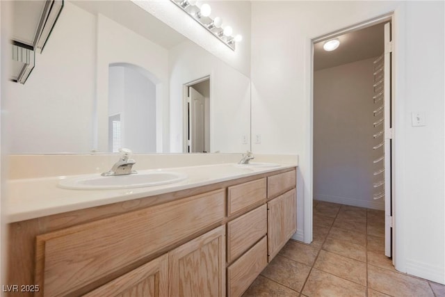 bathroom featuring tile patterned flooring and vanity