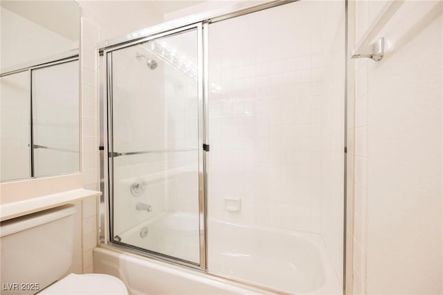 bathroom with enclosed tub / shower combo and toilet