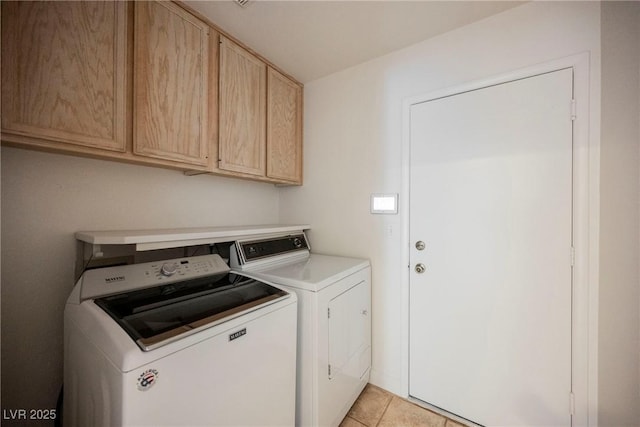 clothes washing area featuring cabinets, light tile patterned floors, and independent washer and dryer