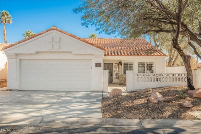 mediterranean / spanish-style house with a garage