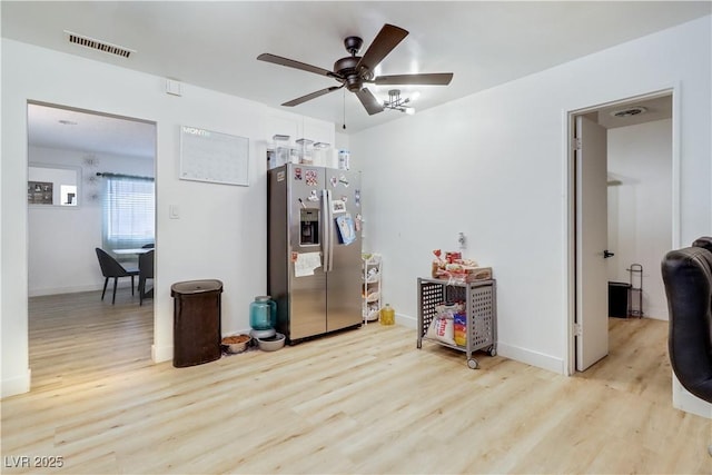 interior space with ceiling fan and light hardwood / wood-style floors