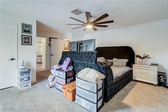 carpeted bedroom featuring a textured ceiling and ceiling fan