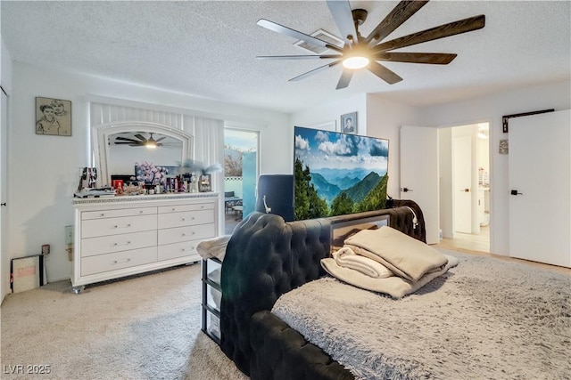 carpeted bedroom featuring ceiling fan and a textured ceiling