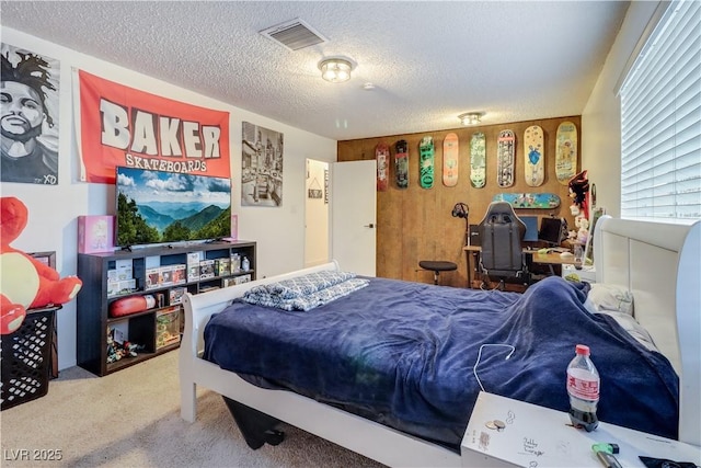 carpeted bedroom with a textured ceiling