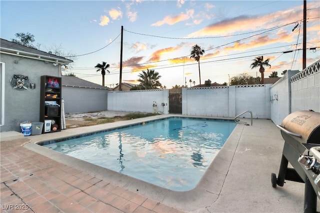 pool at dusk with a patio