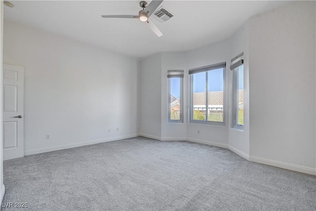 empty room featuring ceiling fan and light carpet