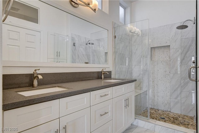 bathroom featuring vanity and an enclosed shower