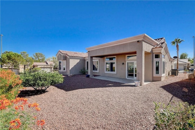 10300 Bent Brook Pl, Las Vegas, NV 89134 - rear view of house with a patio area, stucco siding, a tile roof, and fence