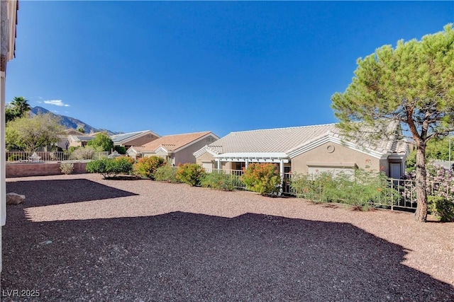 view of yard with a mountain view and a garage