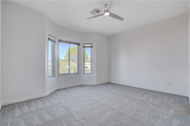 spare room featuring carpet flooring and ceiling fan