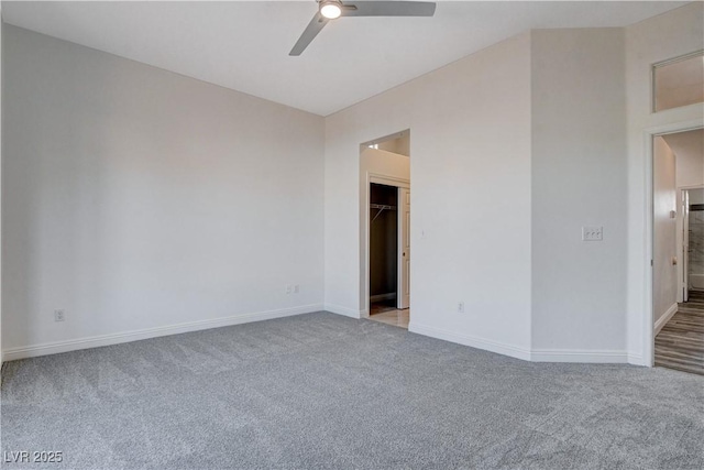 carpeted empty room featuring ceiling fan