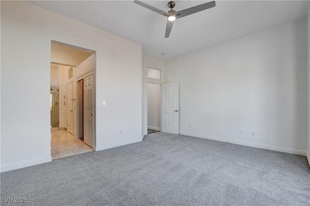 unfurnished bedroom with connected bathroom, light colored carpet, and ceiling fan