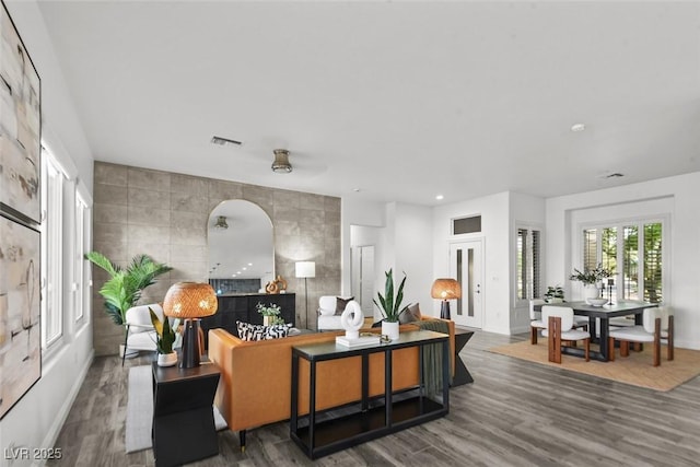 10300 Bent Brook Pl, Las Vegas, NV 89134 - living room with visible vents, baseboards, wood finished floors, and tile walls