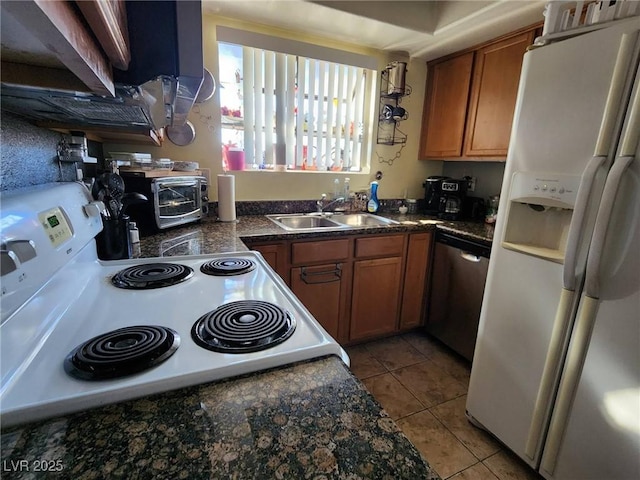 kitchen featuring white appliances, sink, and light tile patterned floors