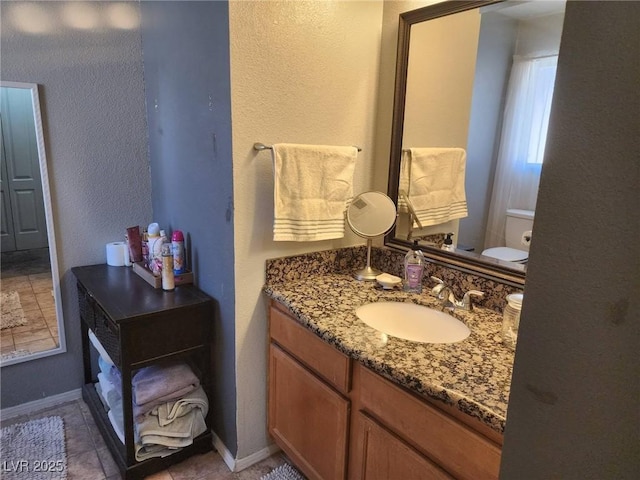 bathroom with toilet and vanity