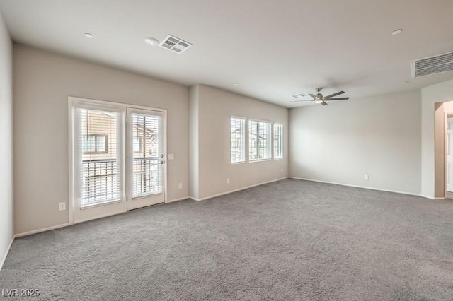 carpeted spare room featuring ceiling fan