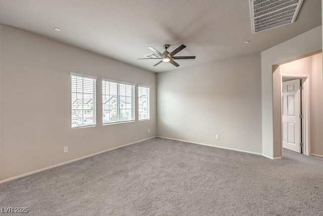 carpeted spare room featuring ceiling fan