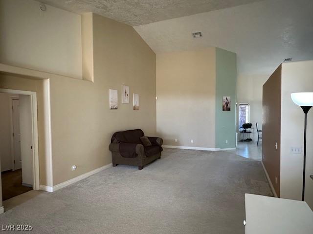 unfurnished room featuring carpet and vaulted ceiling