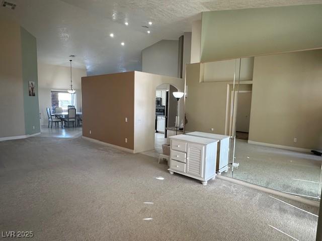 kitchen with pendant lighting and a towering ceiling