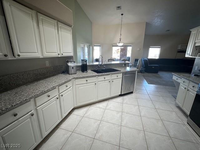 kitchen with white cabinetry, dishwasher, sink, pendant lighting, and light tile patterned flooring