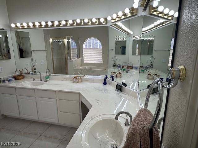 bathroom with tile patterned floors, a shower with door, and vanity