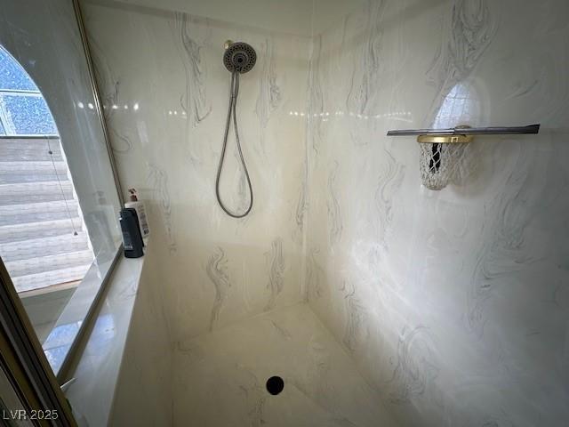 bathroom with a tile shower