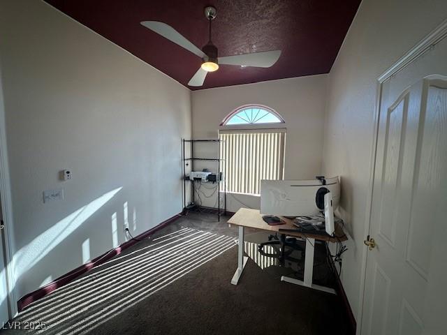 home office with dark colored carpet and ceiling fan