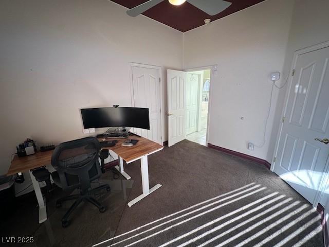 office area with ceiling fan and dark carpet