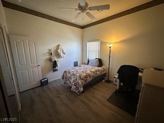 bedroom featuring ceiling fan and dark wood-type flooring