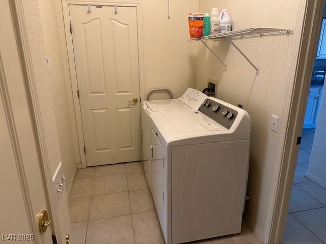 washroom featuring separate washer and dryer and light tile patterned floors