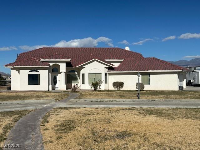 mediterranean / spanish-style house with a front lawn