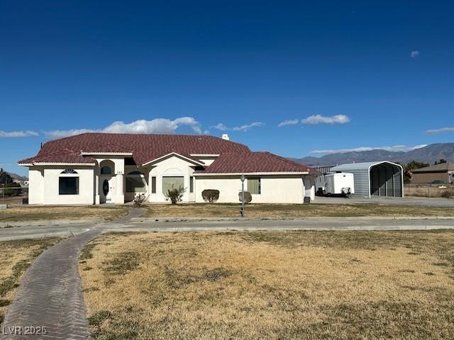 view of front of property with a mountain view and a carport