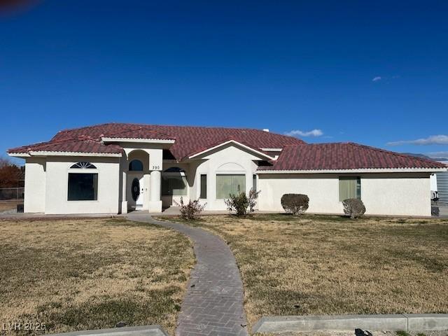 mediterranean / spanish house with a front lawn