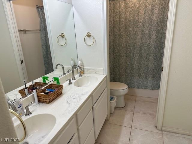 bathroom featuring tile patterned flooring, vanity, and toilet