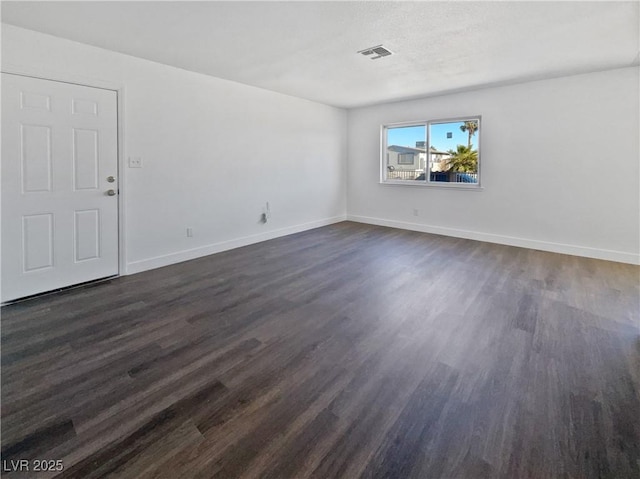 empty room featuring dark hardwood / wood-style flooring