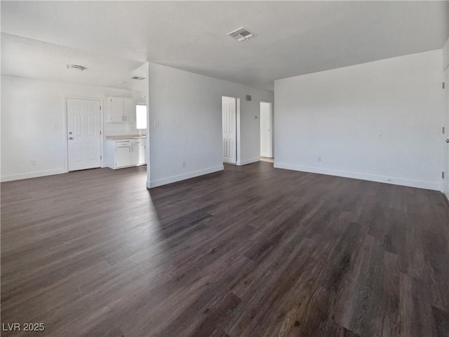 unfurnished living room featuring dark wood-type flooring