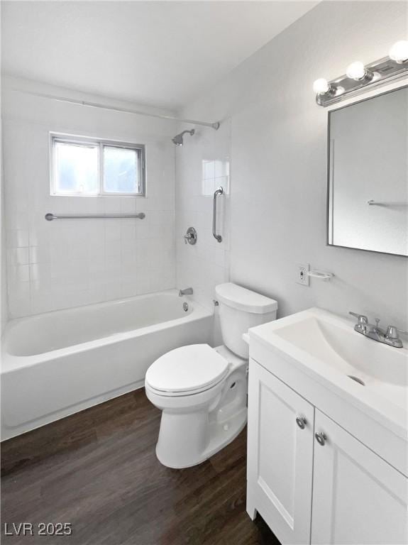 full bathroom with hardwood / wood-style flooring, vanity, toilet, and tiled shower / bath